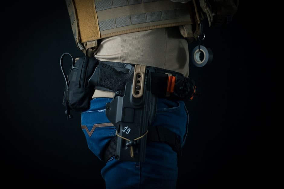 close up of personal defense gear worn on a belt including a holster