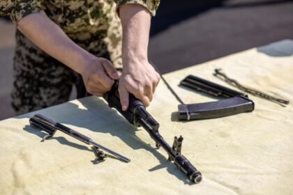 Disassembled rifle laid out on a table during routine cleaning and lubrication