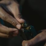 hands loading cartridges into a pistol magazine after a range session