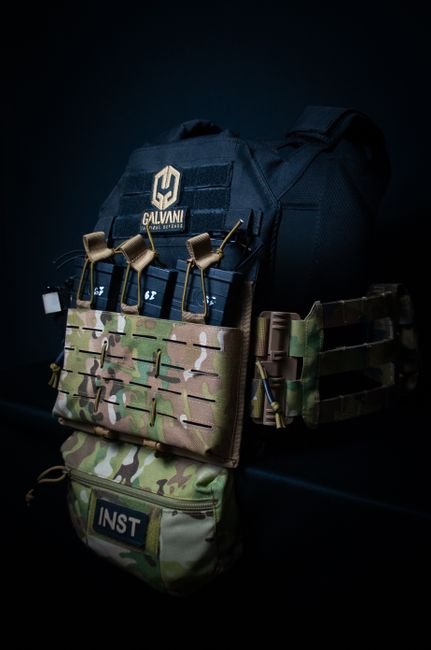 Close-up of a camouflage tactical vest with attached equipment