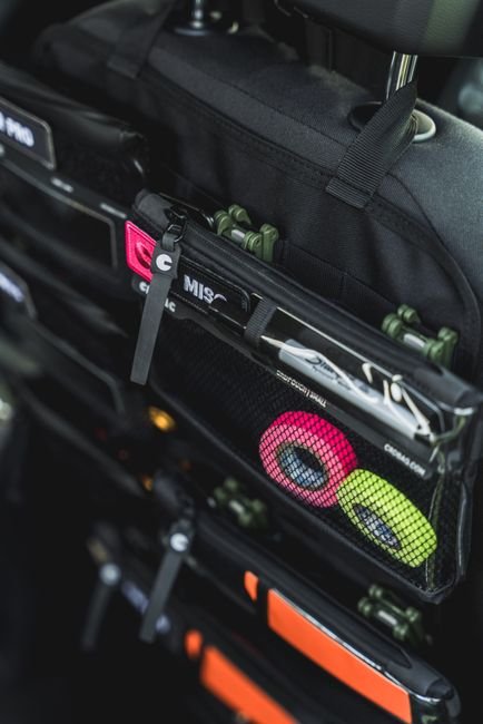 Organized car seat back storage with several bags and pouches