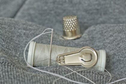 pexelsphoto35166552 edc deals thimble needle and thread laid out for emergency repairs to pocket gear