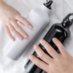 two insulated commuter water bottles held in hand showing lid and seal design