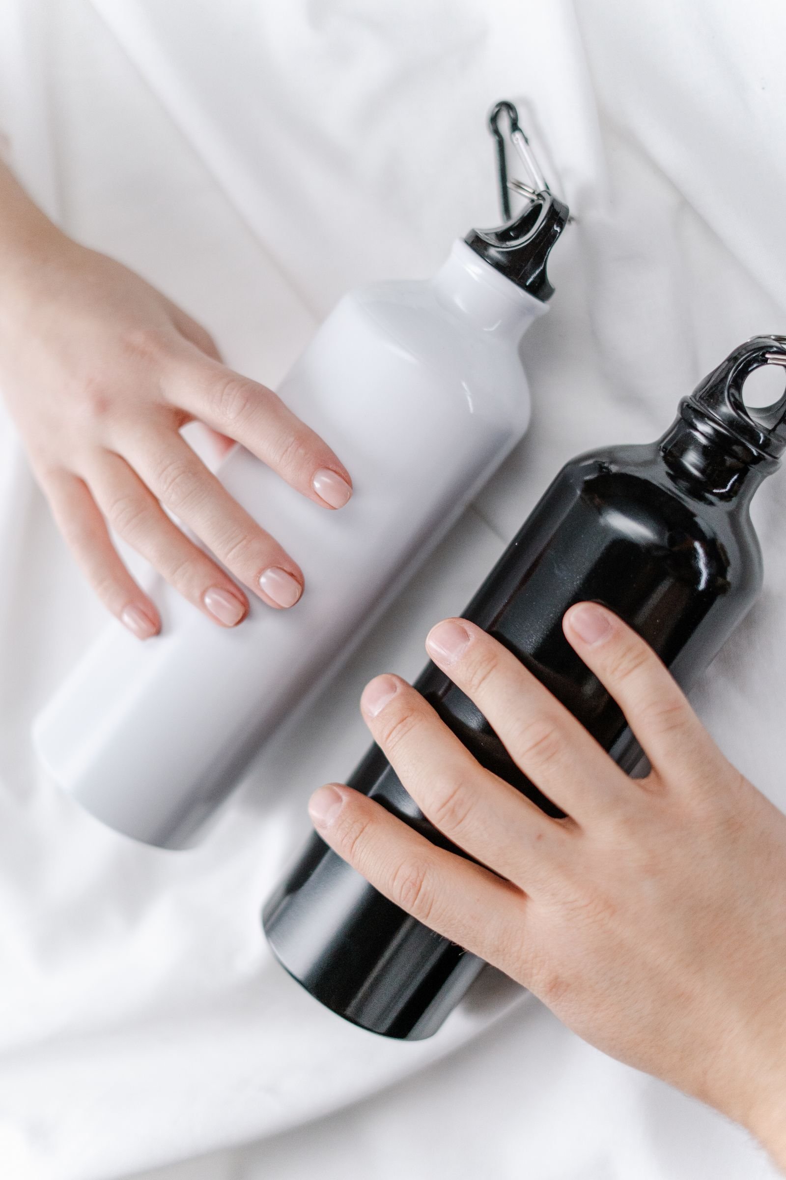 pexelsphoto3737800 edc deals two insulated commuter water bottles held in hand showing lid and seal design