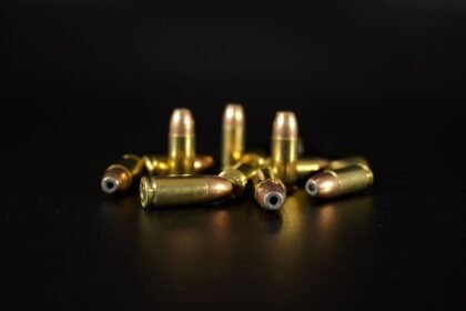 Close-up of brass and copper handgun cartridges side by side