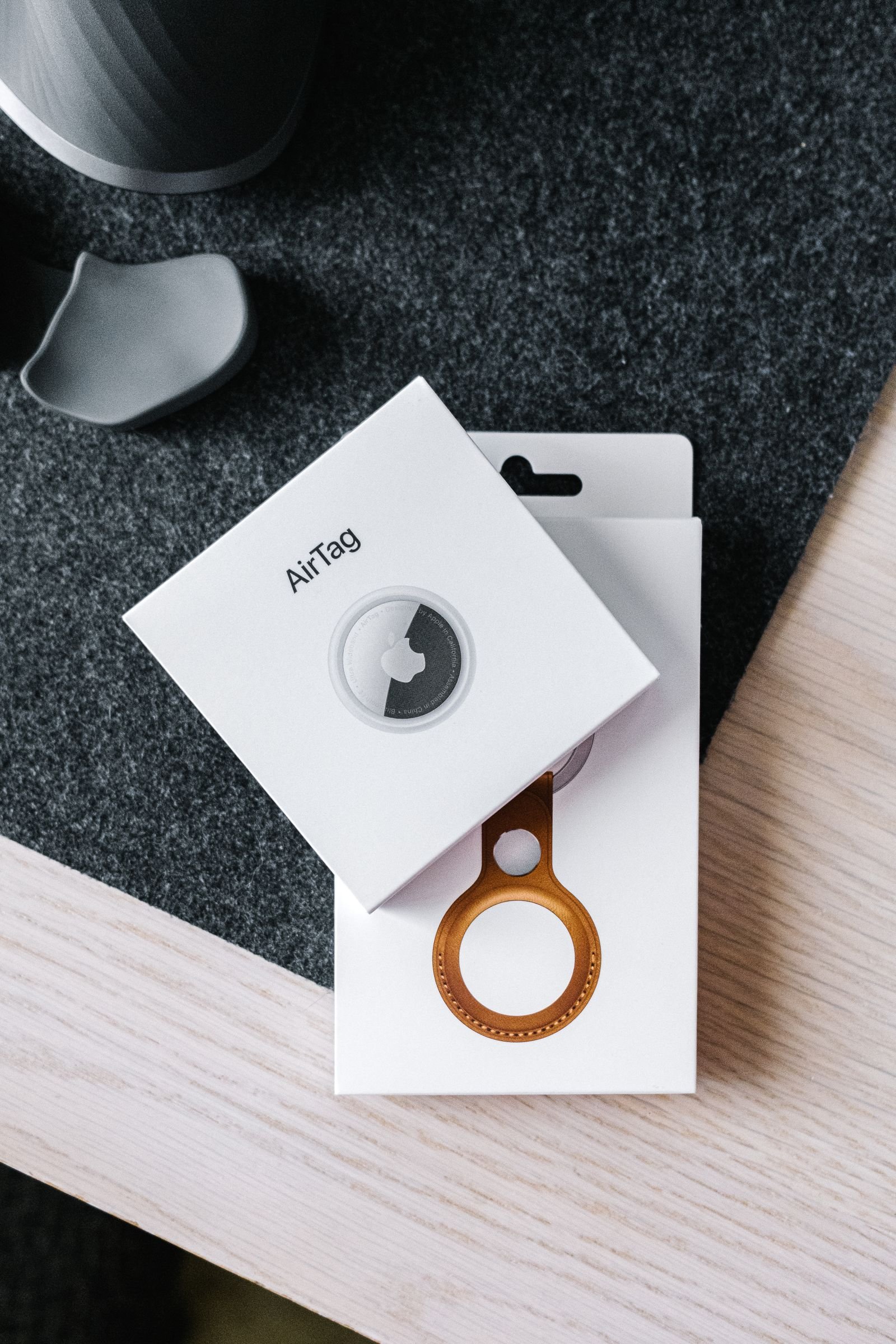pexelsphoto7825627 edc deals apple airtag and leather key ring packaging on a wooden surface