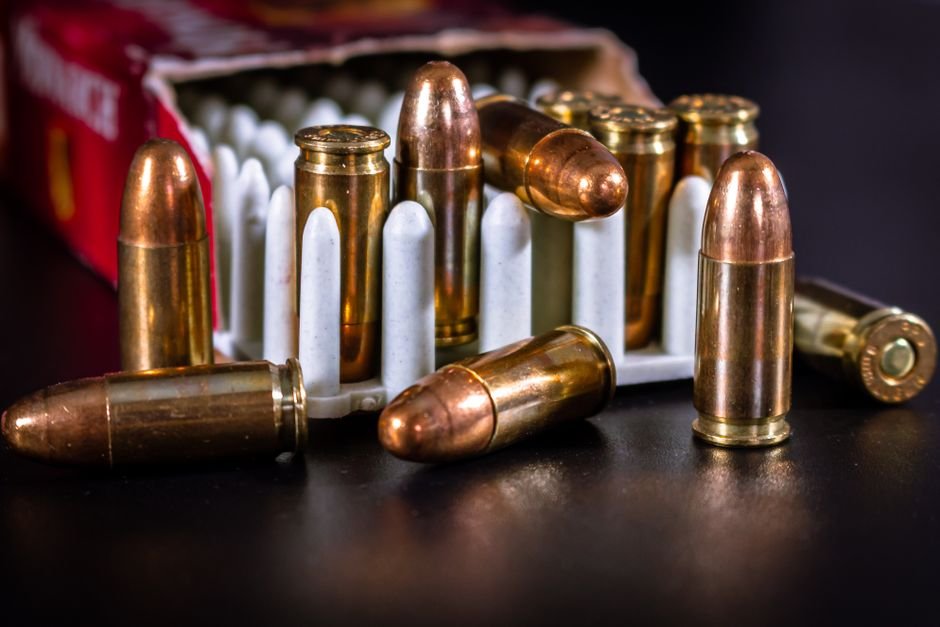 copper cased handgun cartridges in an ammunition container