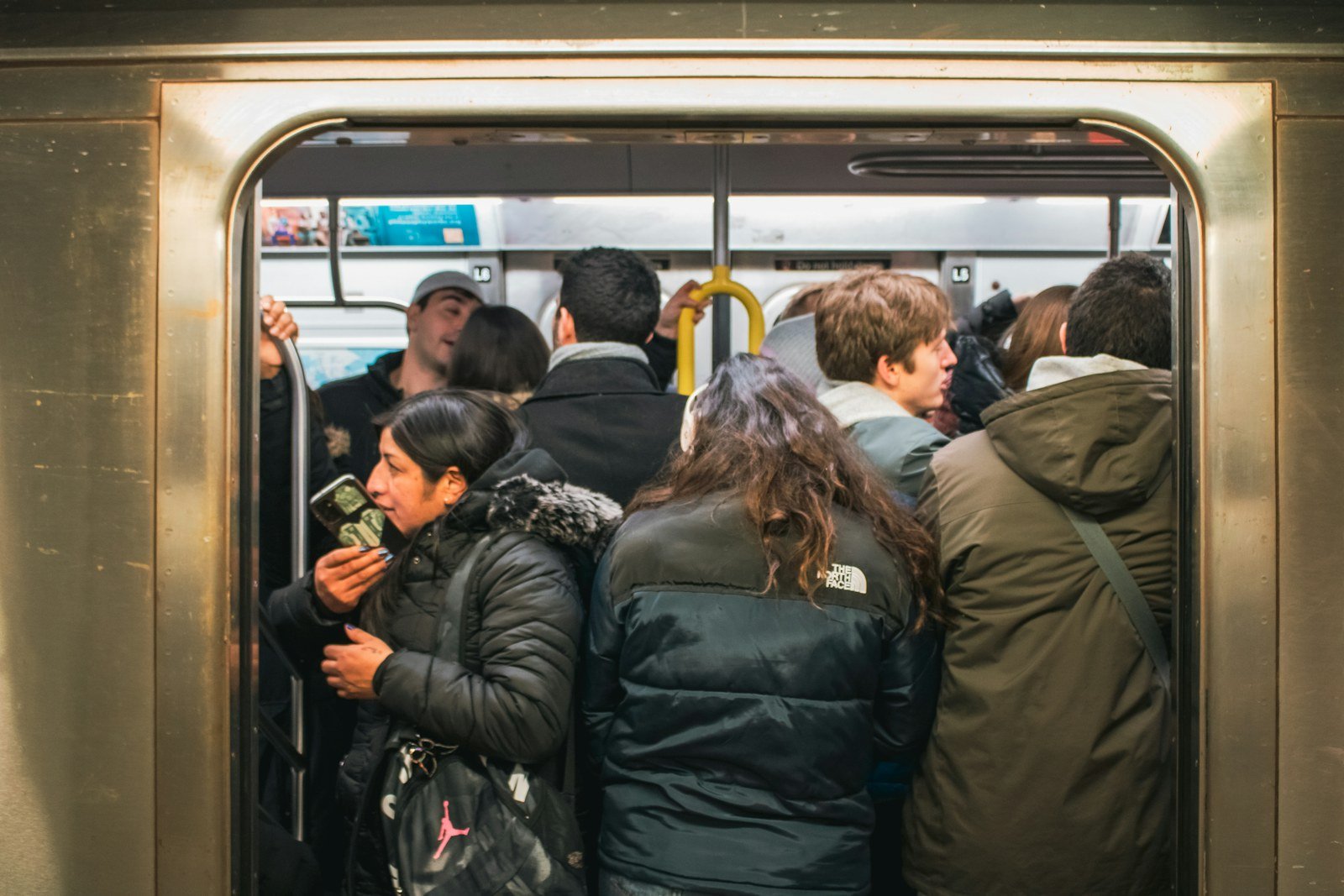 crowded subway train with passengers standing closely together during rush hour