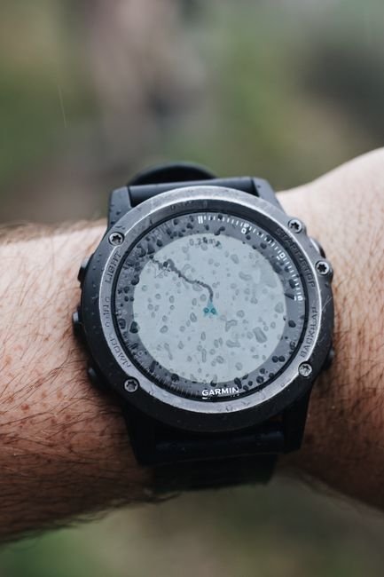 close up of a rugged gps outdoor watch with water droplets