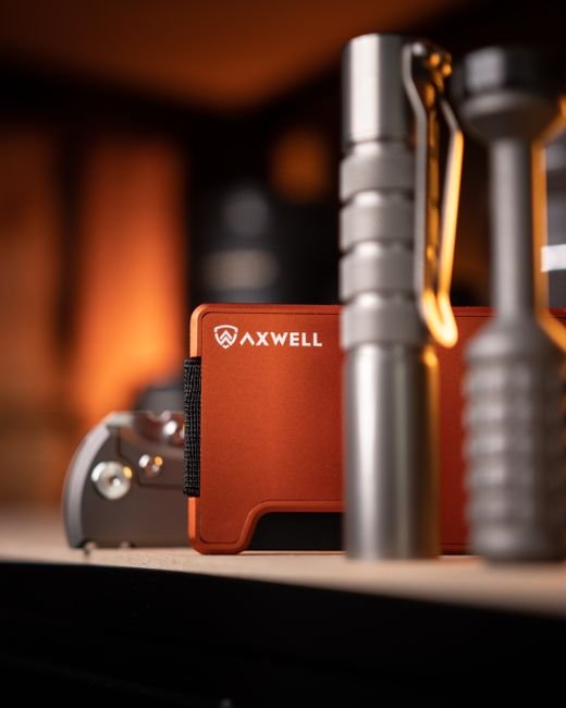 flashlight and multitool on a wooden surface