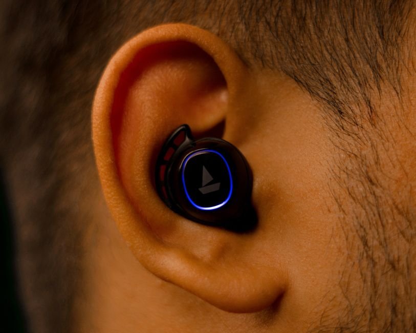 a close up view of a wireless earbud seated in a human ear