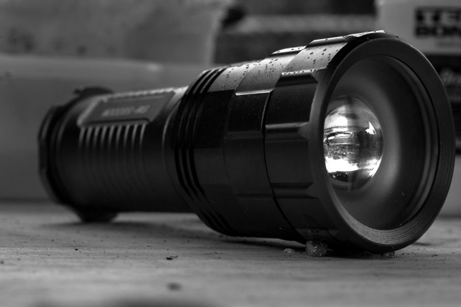 close up of a tactical flashlight showing its body and beam focusing head similar to the streamlight protac hpl usb