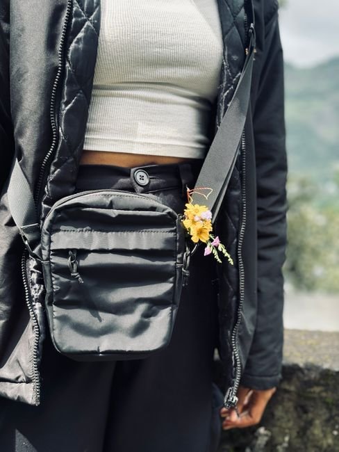 a woman wearing a small crossbody bag outdoors