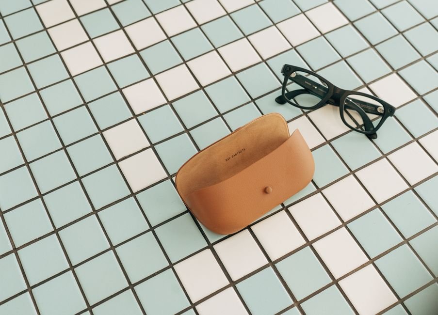 folded eyeglasses beside their protective case