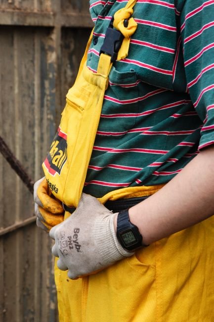 construction worker wearing gloves and a rugged watch on site