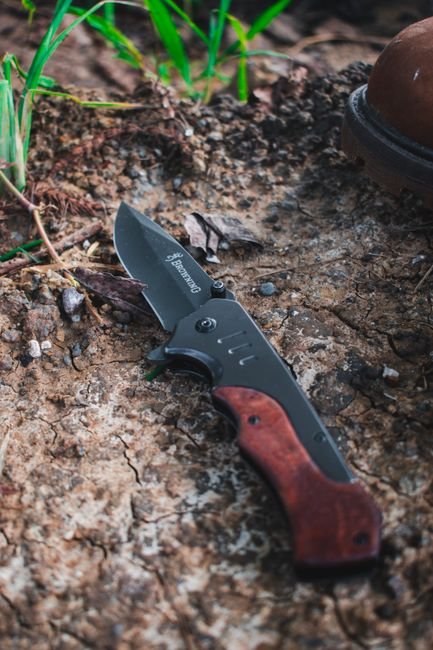 pexels5224633 edc deals close up of a folding pocket knife with wooden handle on rustic ground