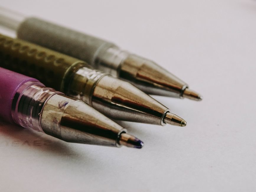 macro view of three ballpoint pen tips showing different tip profiles