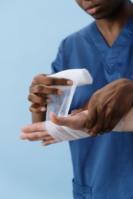 pexels5721552 edc deals a healthcare professional wrapping a patient's hand with gauze