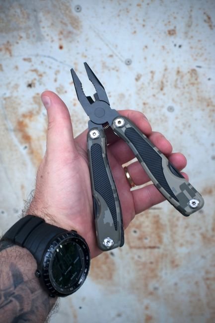 hand gripping a multi tool's pliers, showing how the handle fits in the palm
