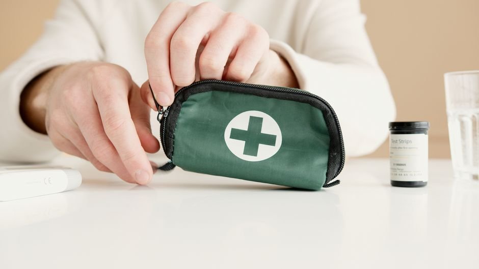 hands holding a small first aid pouch