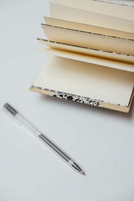 pexels7657397 edc deals a pen resting beside an open pocket notebook