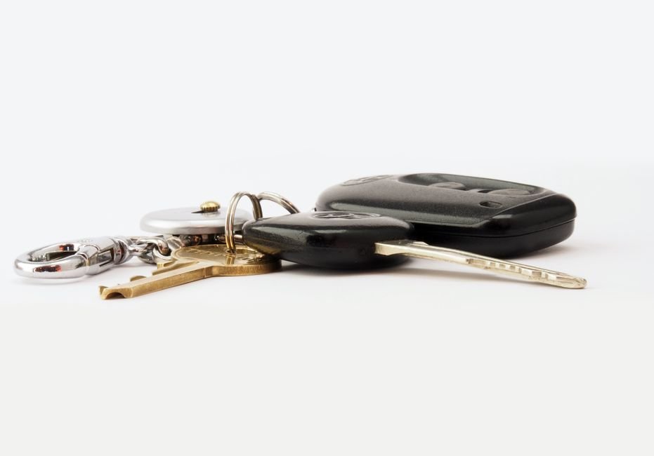 car keys with a key fob and keychain organizer on a white surface