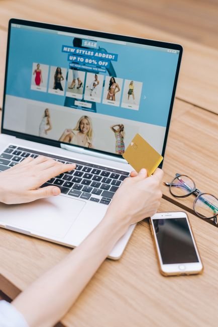 a shopper checking an online listing and credit card before completing a checkout