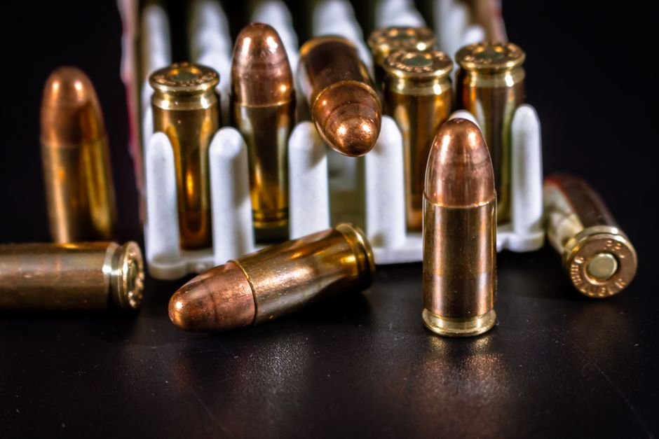 hollow point defensive ammunition rounds arranged on a dark surface