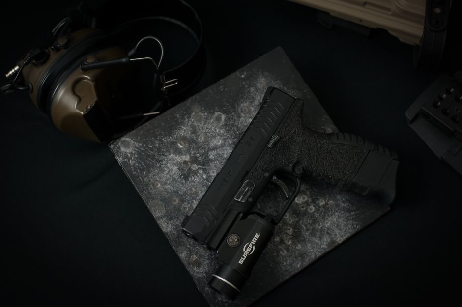 firearm with an m lok mounted tactical weapon light attached to the rail