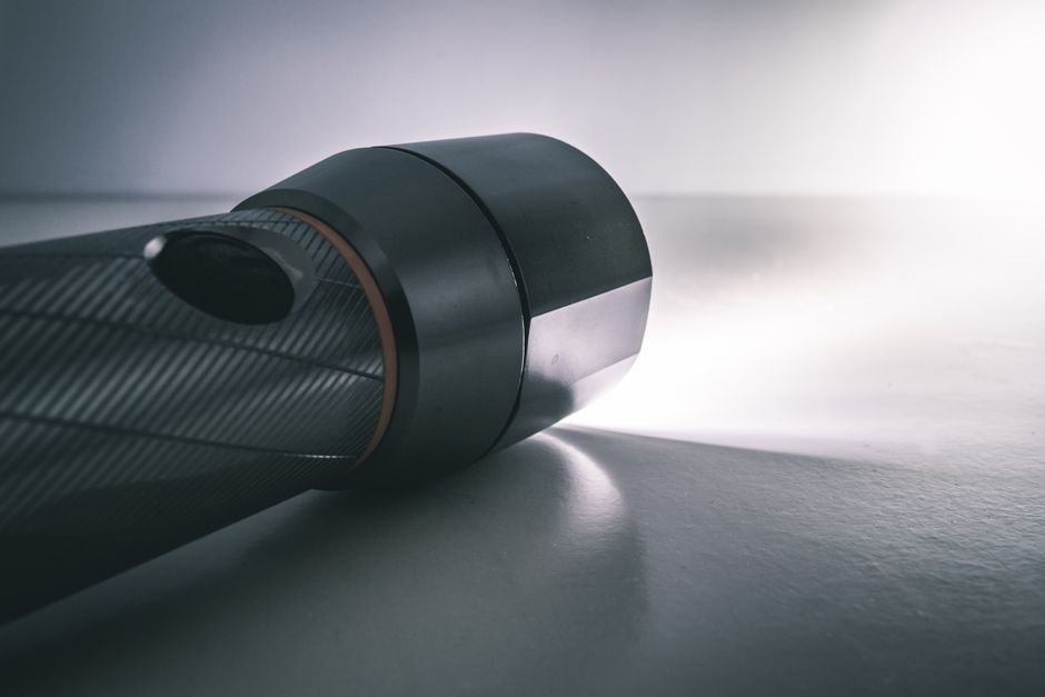 pexels985117 edc deals illuminated flashlight beam against a dark background central to any weapon light home defense plan