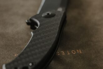 carbon fibre folding pocket knife on leather blade profile visible