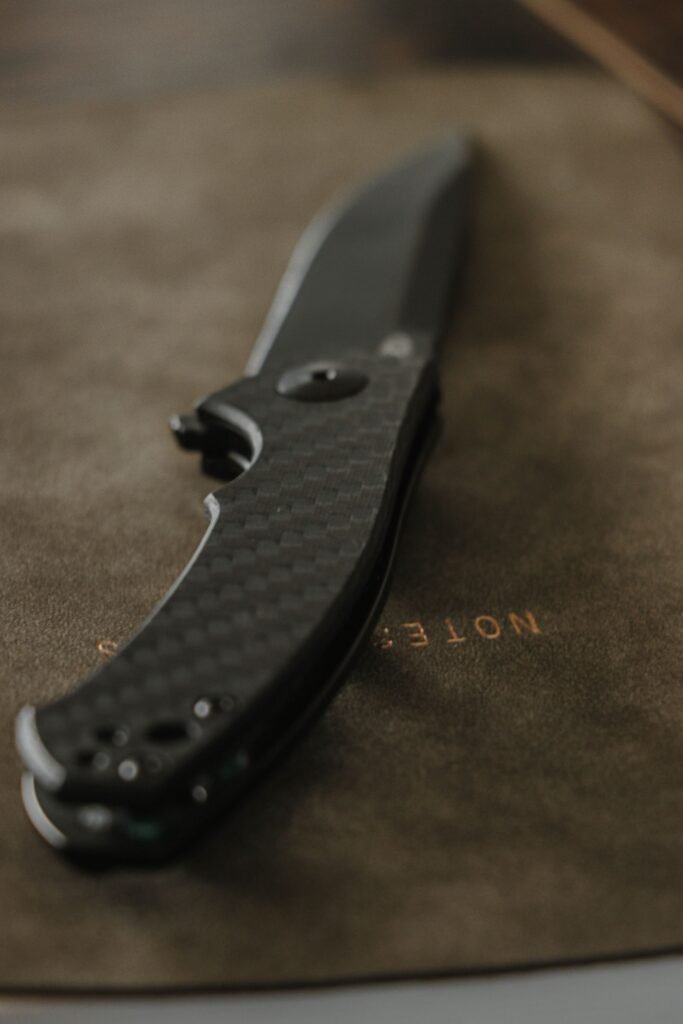 carbon fibre folding pocket knife on leather blade profile visible