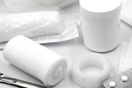 Gauze, tape, safety pins and dressings from a compact first aid kit