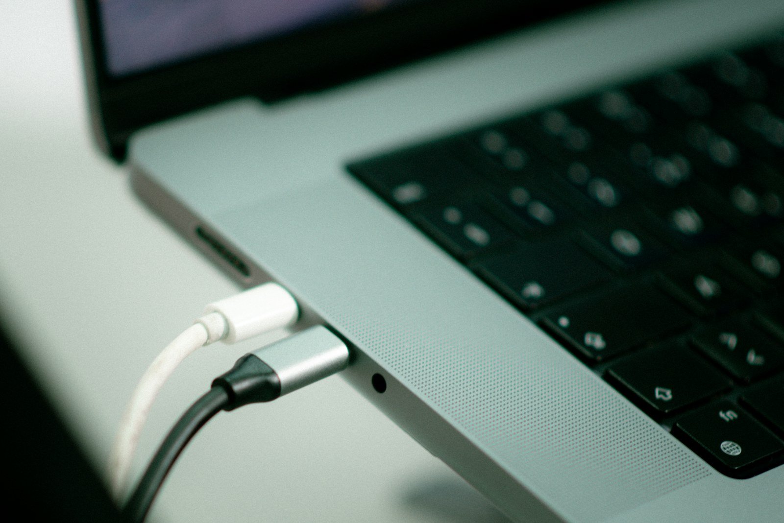 charging cable plugged into a laptop's USB-C port