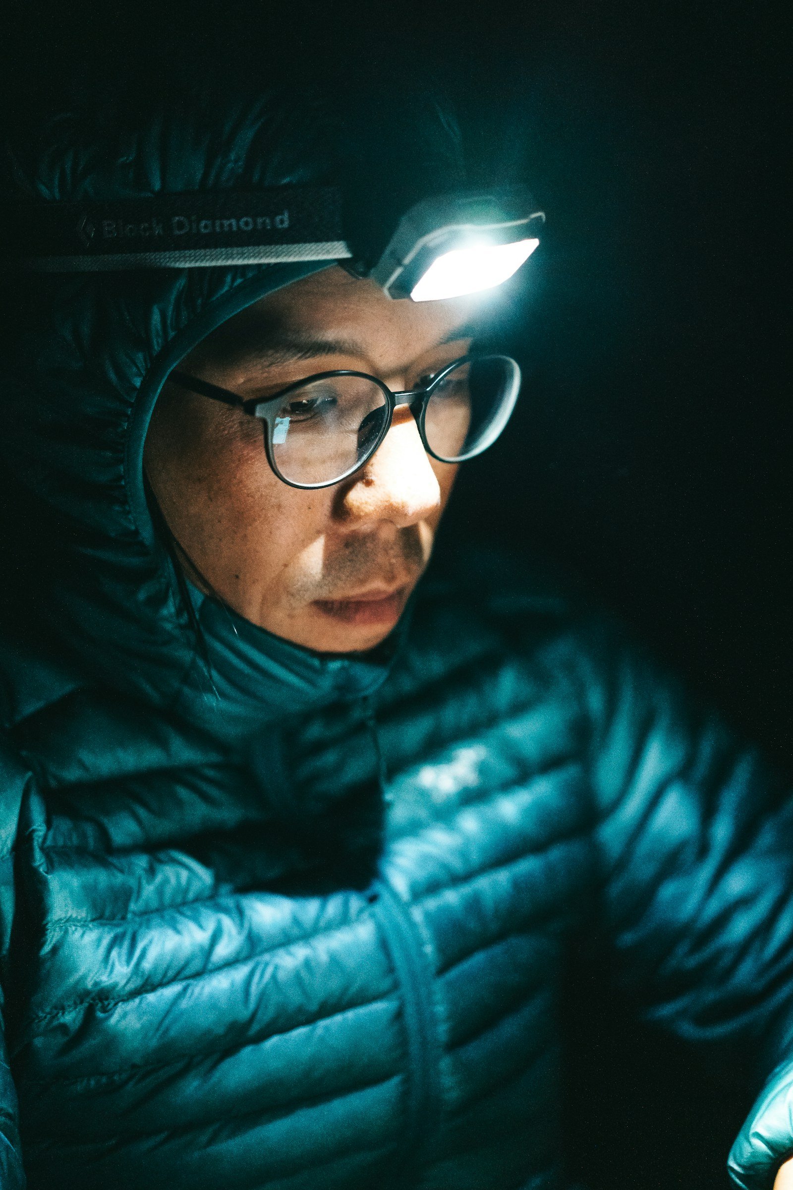 runner wearing a headlamp secured on the forehead at night