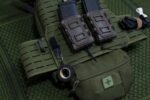 Nylon pouches mounted on a load-bearing rig, exposed to the elements