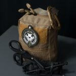 compact tactical pouch with tools laid out beside it
