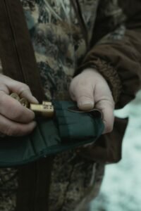 loading shotgun shells into a shell holder brass ends visible